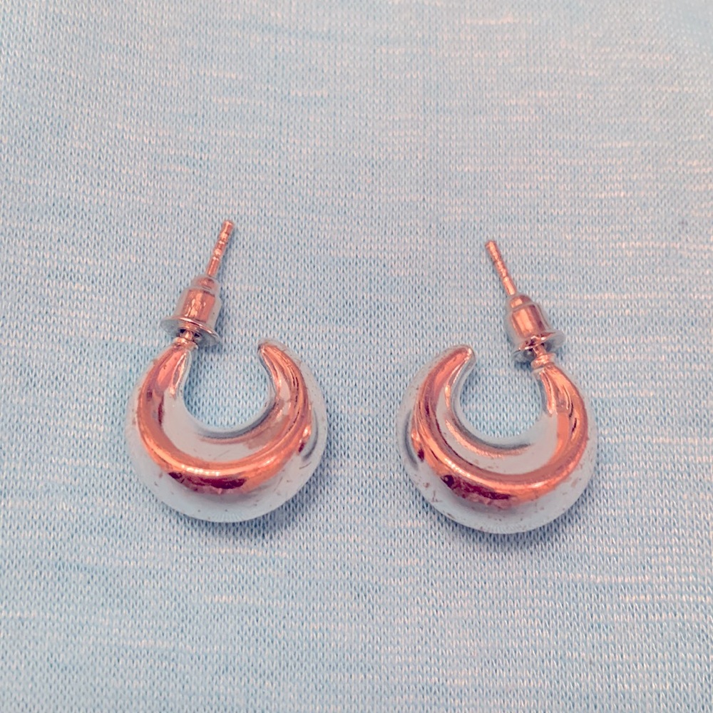 Small silver tone earrings.